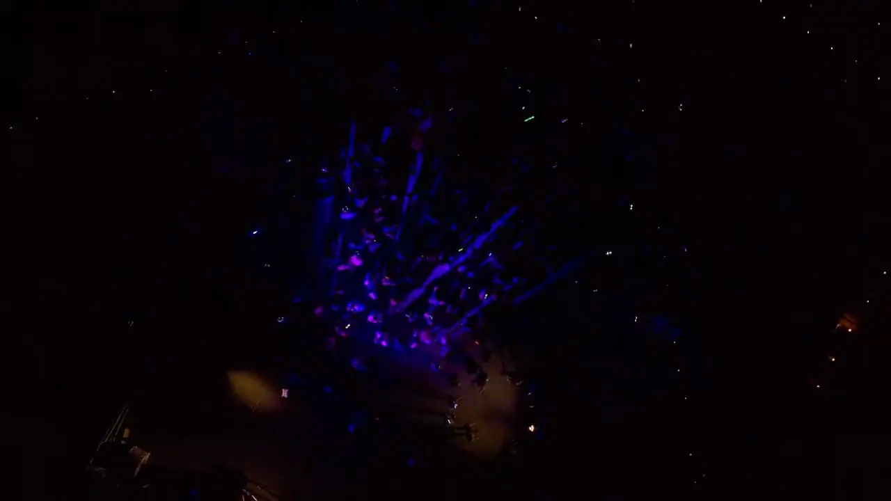 Aerial view of a night-time crowd under stage lights (atmosphere reel)